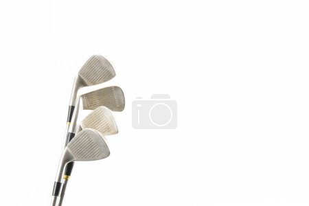 Téléchargez les photos : Close up of four golf clubs with copy space on white background. Golf, sports and competition concept. - en image libre de droit