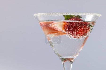Foto de Glass with drink and fruits over grey background. Drinks, cocktails, alcohol, beverages and party concept. - Imagen libre de derechos