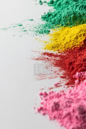 Téléchargez les photos : Close up of multi coloured powder and copy space on white background. Holi festival, colour, hindu tradition and celebration concept. - en image libre de droit