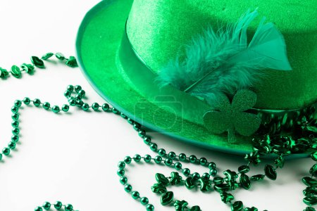 Photo for Image of green hat, green clover, green necklace and copy space on white background. St patrick's day, irish tradition and celebration concept. - Royalty Free Image