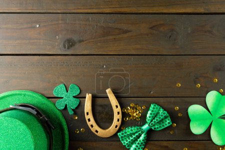 Photo for Image of green hat, green clover, horse shoe and copy space on wooden background. St patrick's day, irish tradition and celebration concept. - Royalty Free Image