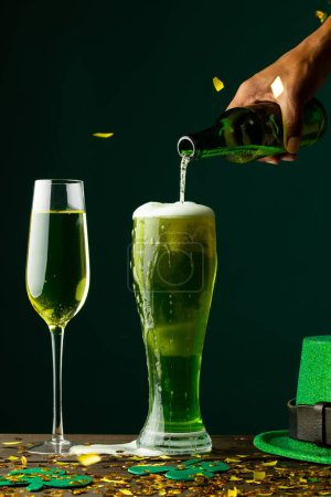 Photo for Image of beer and champagne glasses, green hat and copy space on green background. St patrick's day, irish tradition and celebration concept. - Royalty Free Image