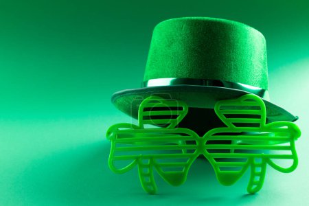 Photo for Image of green hat, green clover glasses and copy space on green background. St patrick's day, irish tradition and celebration concept. - Royalty Free Image
