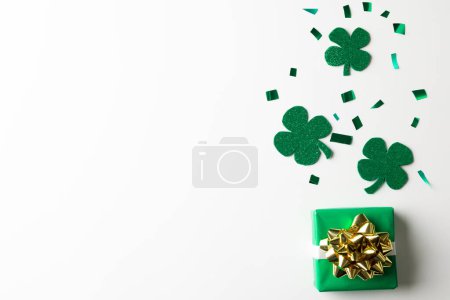 Photo for Image of green clover, green present and copy space on white background. St patrick's day, irish tradition and celebration concept. - Royalty Free Image