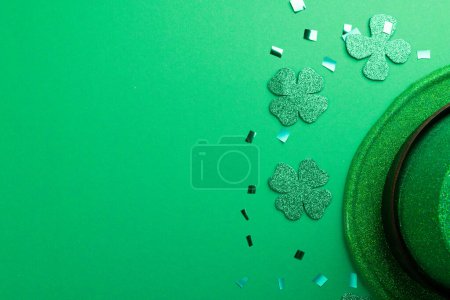 Photo for Image of green hat, clover and copy space on green background. St patrick's day, irish tradition and celebration concept. - Royalty Free Image