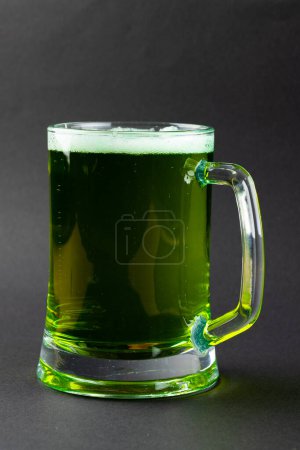 Photo for Image of glass with green beer and copy space on grey background. St patrick's day, irish tradition and celebration concept. - Royalty Free Image