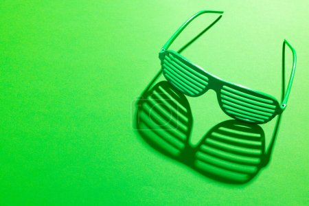Photo for Image of green glasses and copy space on green background. St patrick's day, irish tradition and celebration concept. - Royalty Free Image