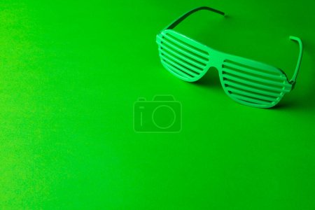 Photo for Image of green glasses and copy space on green background. St patrick's day, irish tradition and celebration concept. - Royalty Free Image