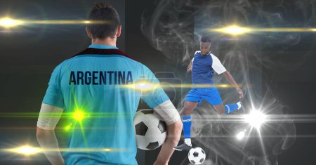 Foto de Smoke effect over two male soccer players against spot of lights on grey background. sports tournament and competition concept - Imagen libre de derechos