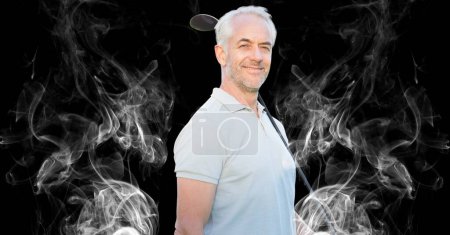 Photo for Senior caucasian male golf player holding golf club against smoke effect on black background. sports and fitness concept - Royalty Free Image