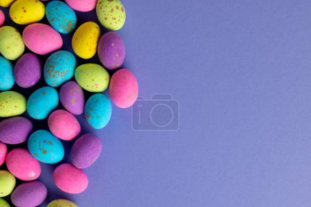 Photo for Image of multi coloured easter eggs with copy space on purple background. Easter, religion, tradition and celebration concept. - Royalty Free Image