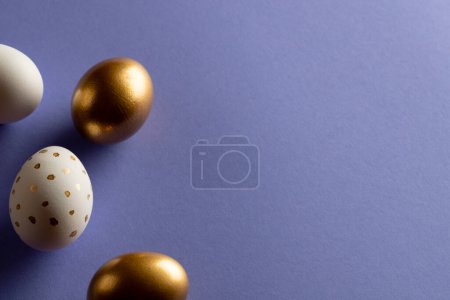 Photo for Image of multi coloured easter eggs and copy space on purple background. Easter, religion, tradition and celebration concept. - Royalty Free Image