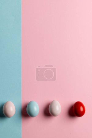 Photo for Image of multi coloured easter eggs with copy space on pink and blue background. Easter, religion, tradition and celebration concept. - Royalty Free Image