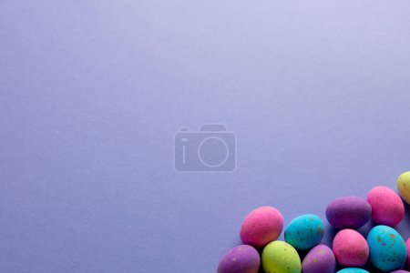 Photo for Image of multi coloured easter eggs with copy space on purple background. Easter, religion, tradition and celebration concept. - Royalty Free Image