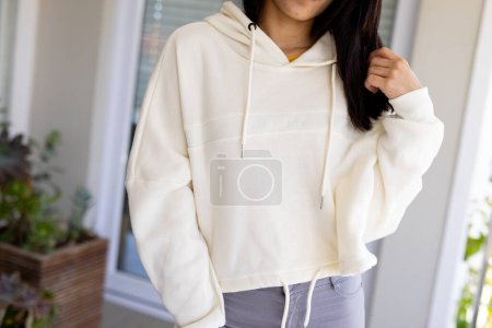 Photo for Midsection of biracial woman wearing white sweatshirt with copy space. Fashion, design, color and clothes concept. - Royalty Free Image