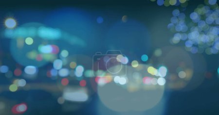 Photo for Close up of light spots over multicoloured city lights on dark background. City, urban and light concept. - Royalty Free Image