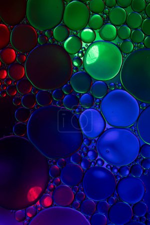 Photo for Macro close up of water bubbles with copy space over multi coloured background. Macro, colour, water, shape and pattern concept. - Royalty Free Image
