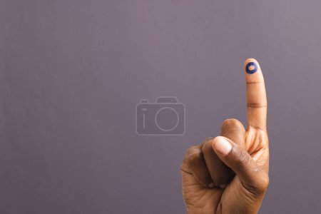 Téléchargez les photos : Main d'homme biracial avec anneau bleu sur doigt tendu, sur fond gris avec espace de copie. Glycémie, diabète et sensibilisation à la santé. - en image libre de droit