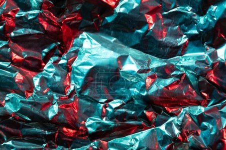 Photo for Close up of crumpled shiny blue and red foil with copy space. Colour, texture and material. - Royalty Free Image