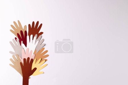Photo for Paper cut out of multi coloured hands with copy space on white background. Humanitarian aid, people, help and human concept. - Royalty Free Image