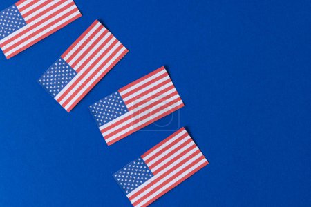 Foto de Vista de ángulo alto de cuatro banderas de estados unidos de América con espacio de copia sobre fondo azul. Patriotismo americano, día de la independencia y concepto de tradición. - Imagen libre de derechos