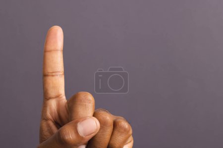 Photo for Hand of biracial man with outstretched forefinger, on grey background with copy space. Pin prick test, blood sugar, diabetes and health awareness. - Royalty Free Image