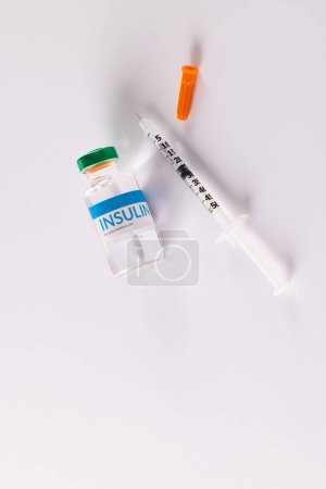 Photo for Insulin vial and uncapped syringe on white background with copy space. Blood sugar, diabetes and health awareness. - Royalty Free Image