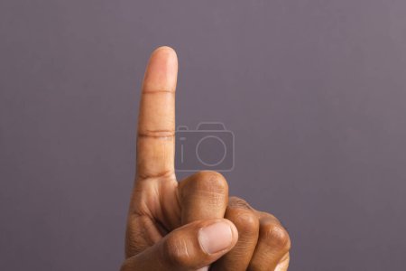 Photo for Hand of biracial man with outstretched forefinger, on grey background. Pin prick test, blood sugar, diabetes and health awareness. - Royalty Free Image