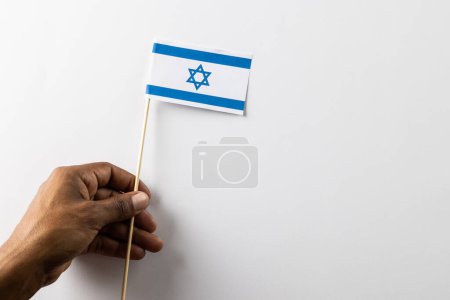 Photo for Close up of biracial man holiday flag of israel with copy space on white background. Jewish religion and tradition. - Royalty Free Image