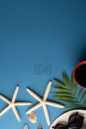 Photo for Straw hat, sunglasses, cup of coffee, plant and seashells on blue background with copy space. Travel and vacation. - Royalty Free Image