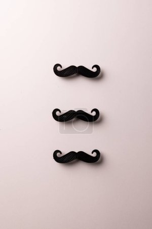 Photo for Composition of fake moustaches on white background with copy space. Fake moustache day, party, celebration and copy space, digital image. - Royalty Free Image