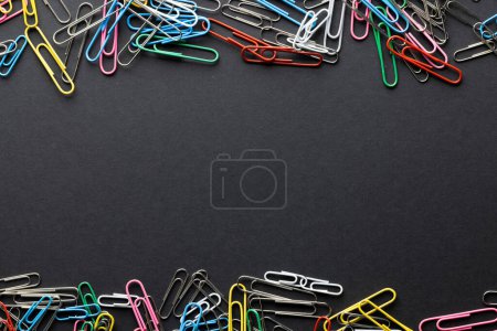Photo for Close up of stack of multi coloured paper clips and copy space on black background. School materials, organising, learning, school and education concept. - Royalty Free Image