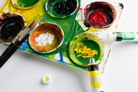 Photo for Close up of paints and brushes with copy space on white background. Back to school, art, painting, school materials, learning, school and education concept. - Royalty Free Image