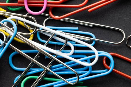 Photo for Close up of close up of multi coloured paper clips on black background. School materials, organising, learning, school and education concept. - Royalty Free Image