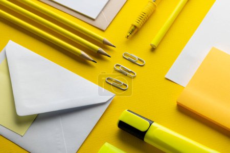 Photo for Flat lay of yellow pencils, pen and highlighter and white paper with copy space on yellow background. School materials, writing, colouring, drawing, learning, school and education concept. - Royalty Free Image