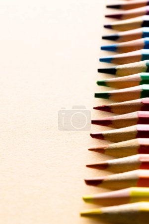 Photo for Close up of multi coloured pencils and copy space on yellow background. Writing, colouring, learning, school and education concept. - Royalty Free Image
