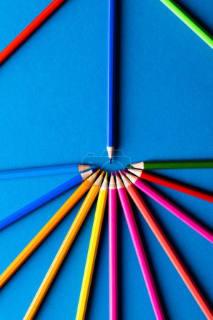 Photo for Close up of multi coloured pencils in circle and copy space on blue background. Writing, colouring, learning, school and education concept. - Royalty Free Image