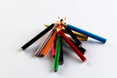 Photo for Close up of stack of coloured pencils with copy space on white background. School materials, writing, colouring, drawing, learning, school and education concept. - Royalty Free Image