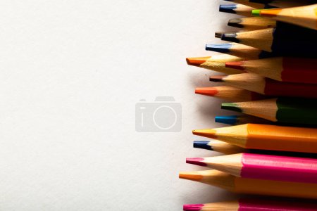 Photo for Close up of multi coloured pencils and copy space on white background. Writing, colouring, learning, school and education concept. - Royalty Free Image