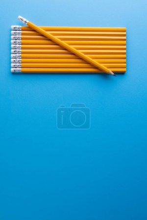 Photo for Close up of yellow pencils with erasers and copy space on blue background. Writing, drawing, learning, school and education concept. - Royalty Free Image