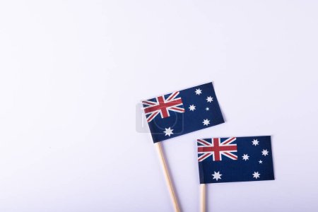 Photo for Overhead view of small australian flags over white background, copy space. National flag, blue, patriotism and identity concept. - Royalty Free Image
