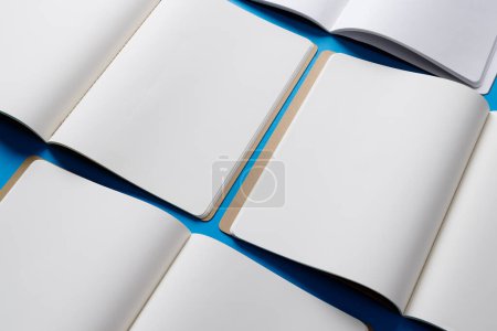 Photo for Close up of open books with copy space on blue background. Literature, reading, writing, leisure time and books. - Royalty Free Image