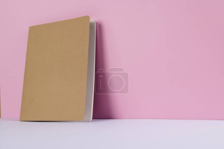Photo for Close up of beige notebook with copy space on pink background. Literature, reading, writing, leisure time and books. - Royalty Free Image
