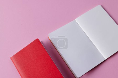 Téléchargez les photos : Gros plan du carnet rouge et du carnet ouvert avec espace de copie sur fond rose. Littérature, lecture, écriture, loisirs et livres. - en image libre de droit