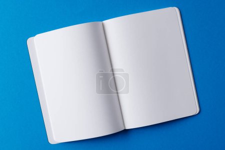 Photo for Close up of open book with copy space on blue background. Literature, reading, writing, leisure time and books. - Royalty Free Image