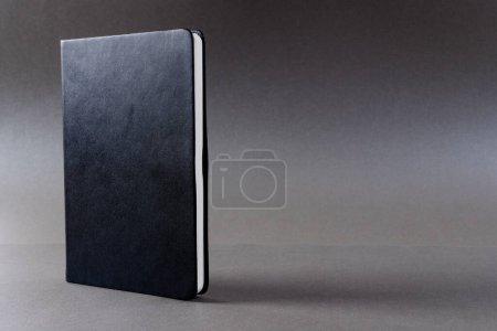 Photo for Close up of black notebook with copy space on black background. Literature, reading, writing, leisure time and books. - Royalty Free Image