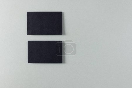 Photo for Black business cards with copy space on grey background. Business, business card, stationery and writing space concept. - Royalty Free Image