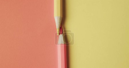 Photo for Close up of red and yellow pencil crayons on red and yellow background with copy space. Stationery, learning, school and education concept. - Royalty Free Image