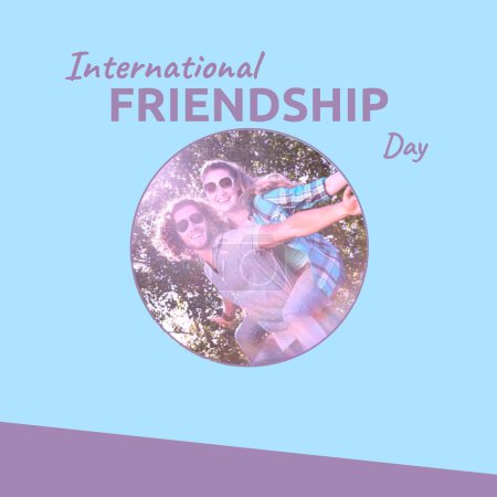 Photo for International friendship day text on blue with happy caucasian couple piggybacking in sun. Celebration of friendship, it's time to celebrate campaign digitally generated image. - Royalty Free Image