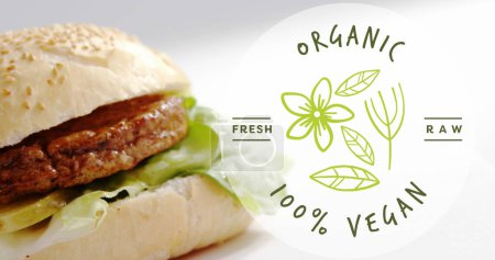 Photo for Animation of vegan food text over vegan burger on wooden board. Vegan food, organic fresh food, and sustainability concept digitally generated video. - Royalty Free Image